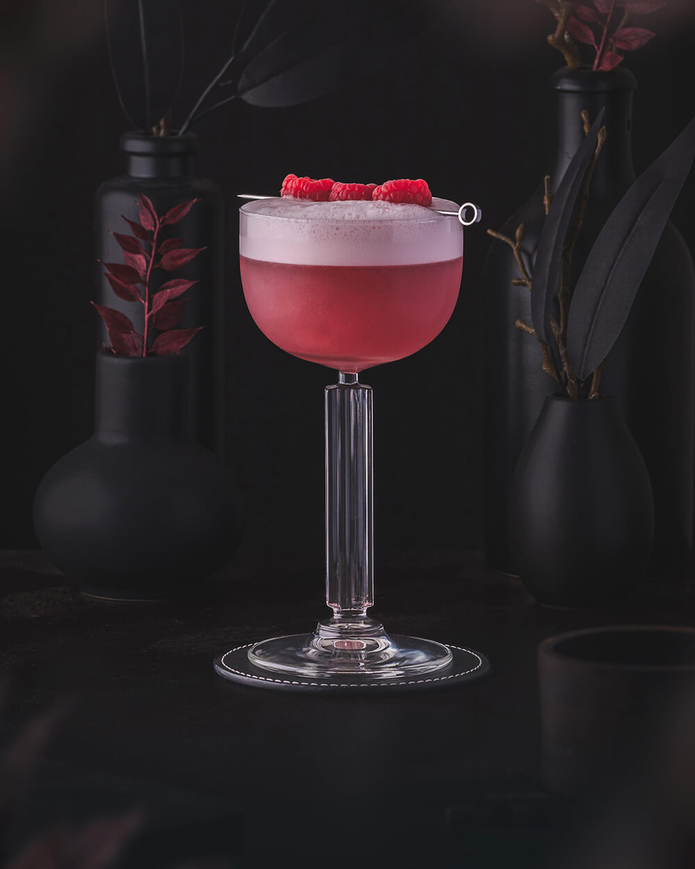 Clover Club Cocktail - Red rosa classic cocktail with foam. Garnished with Raspberries.