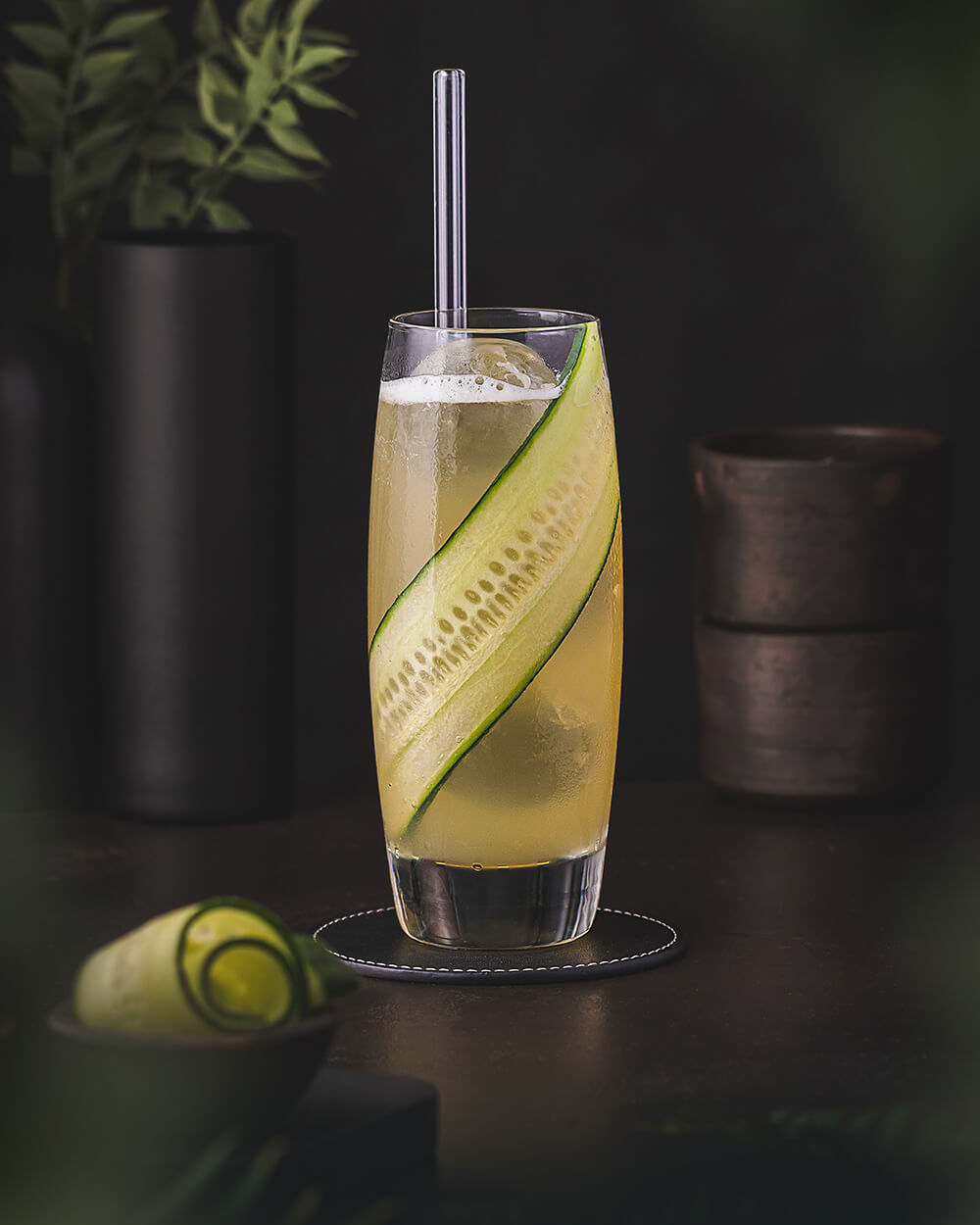 Le Gurk - Cocktail made with gin, Elderflower, apple juice and cucumber. Served in a highball glass garnished with a cucumber.